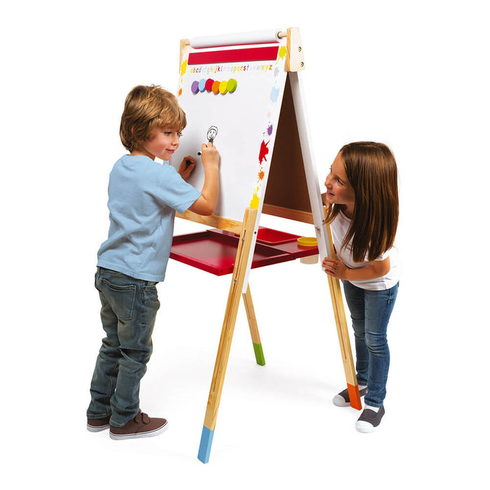 Two children using a wooden double-sided art easel with a whiteboard, red tray, and colorful leg tips.