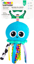 Lamaze blue plush jellyfish with heart-shaped eye glints, colorful patterned ribbons, and a white clip-on hook.