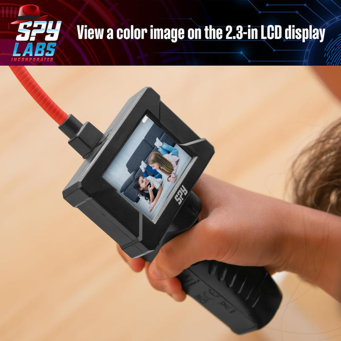 Child holding a black handheld spy device with a 2.3-inch color screen and a flexible red camera cable.