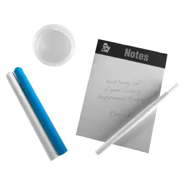 Gray notepad, blue and white markers, clear plastic dish, and a small white brush against a plain white background.