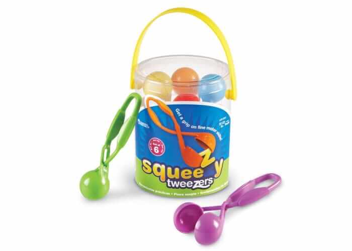 Colorful scoop tweezers in a clear bucket with a yellow handle, plus green and purple tweezers shown outside.