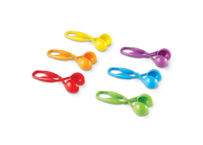 Six colorful plastic scissor-style scoopers in red, orange, yellow, green, blue, and purple.