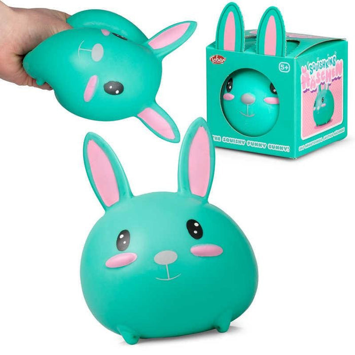 Teal round bunny toy with pink ears and cheeks, shown being squeezed, in packaging, and sitting upright.