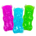 Three translucent, glitter-filled squishy toys shaped like gummy bears in bright pink, blue, and green.
