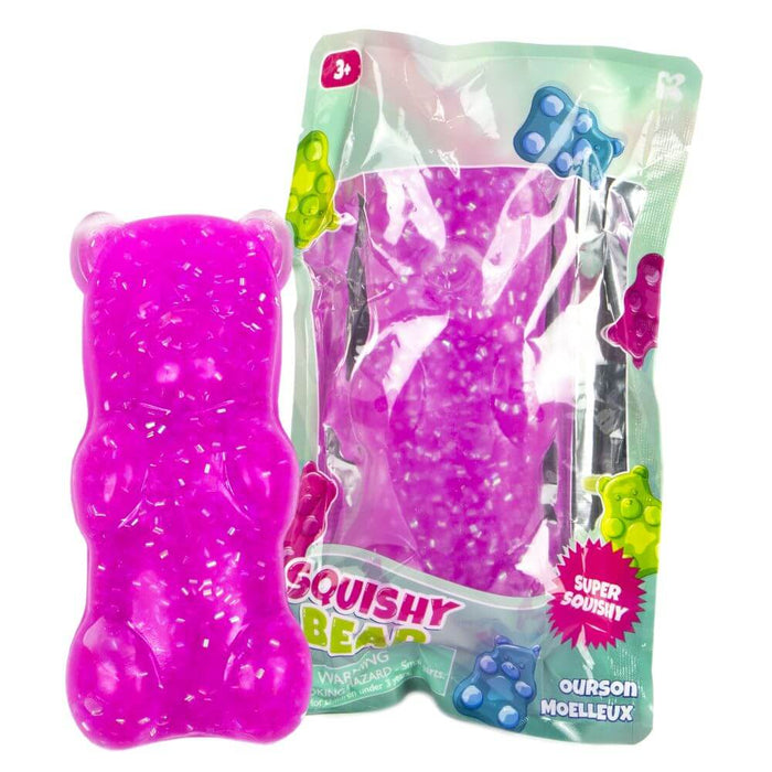 Translucent purple bear squishy toy with white confetti interior, next to its green and clear retail packaging.