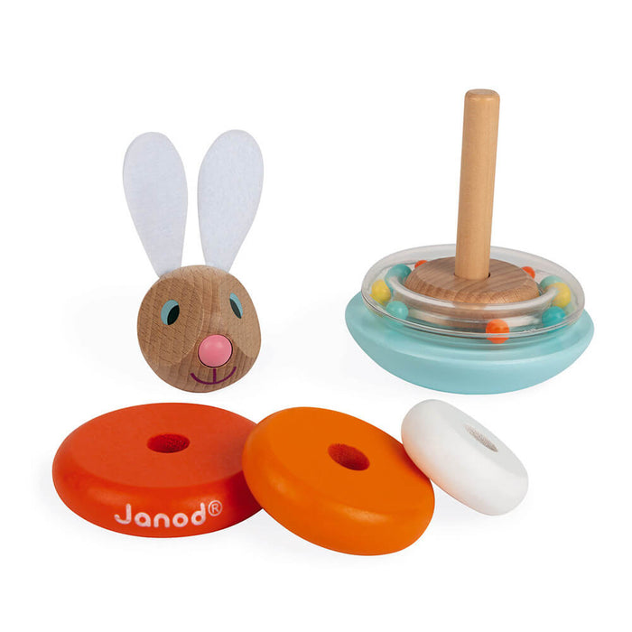 Disassembled wooden rabbit toy with felt ears, orange and white rings, and a blue base with a clear rattle ring.