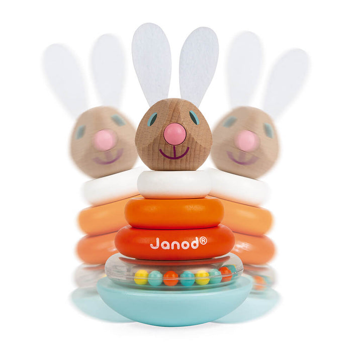 Wooden rabbit stacker with white, orange and red rings on a blue rocking base containing colorful beads.