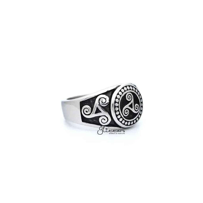 Stainless steel men's ring with antiqued triskele and triple spiral design, featuring detailed casting from Glitters.