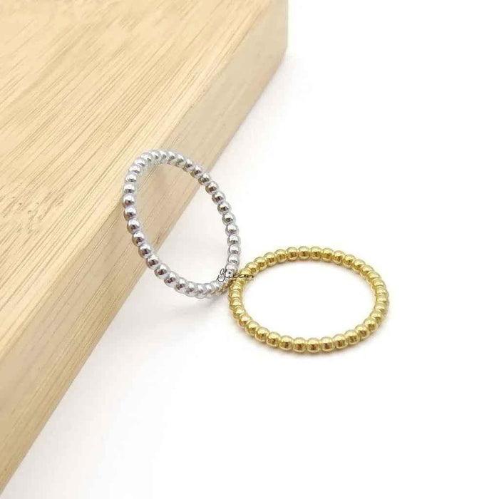 Silver stainless steel bead stacking ring by Glitters, showcasing a sleek, modern design with multiple small beads on a smooth band.
