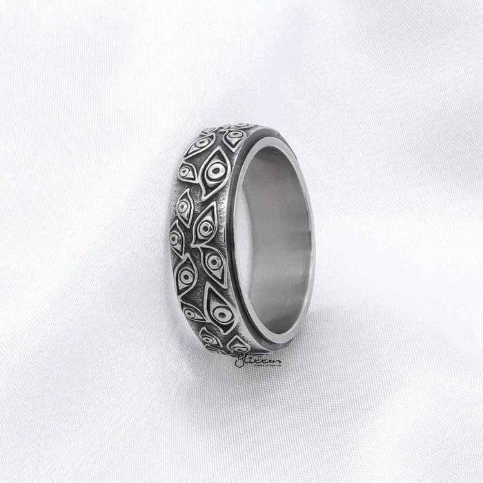Silver stainless steel Eye of God spinner ring by Glitters featuring detailed design and smooth bands on a white background.