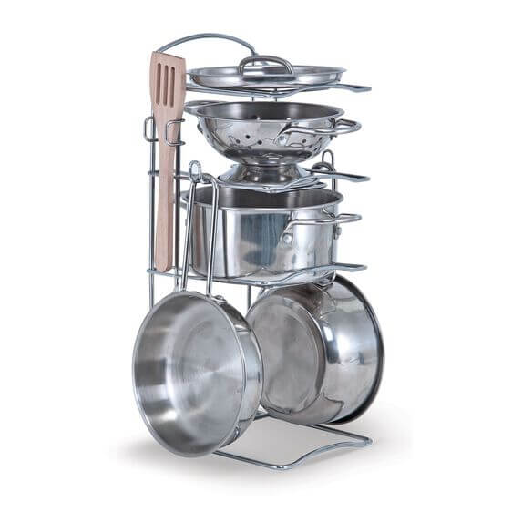 Shiny stainless steel toy pots, pans, and colander on a tiered wire rack with a wooden spatula.