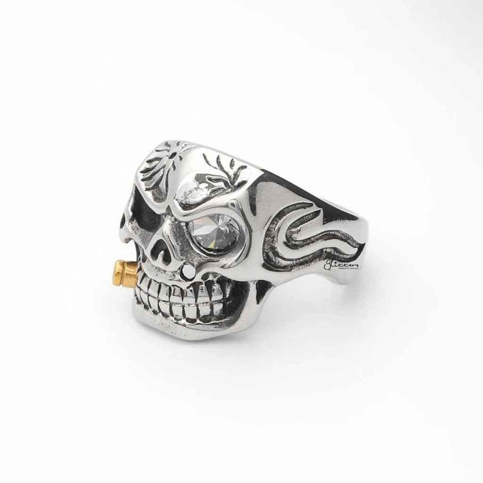 Stainless steel skull ring with gold bullet detail from Glitters, featuring a detailed skull design and metallic finish.