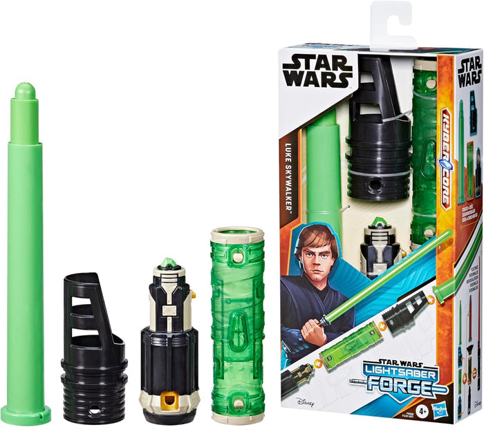 Green extendable blade, black hilt pieces, and a green core alongside a toy box featuring Luke Skywalker artwork.