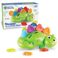 Green toy stegosaurus with colorful numbered spikes and slots, shown with its product box.