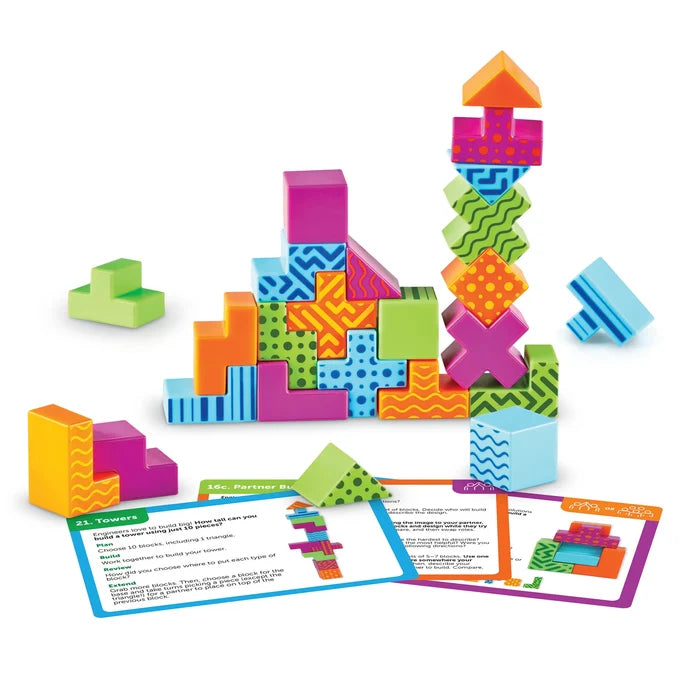 Vibrant patterned 3D geometric blocks built into towers and shapes alongside STEM challenge cards.