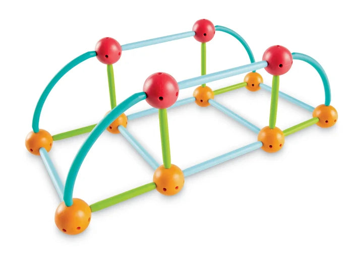 Colorful construction toy bridge built with red and orange spheres and straight blue, green, and curved teal rods.