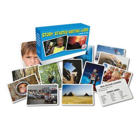 Blue box of writing cards surrounded by scattered photo prompts of people, landscapes, a robot, and an ambulance.