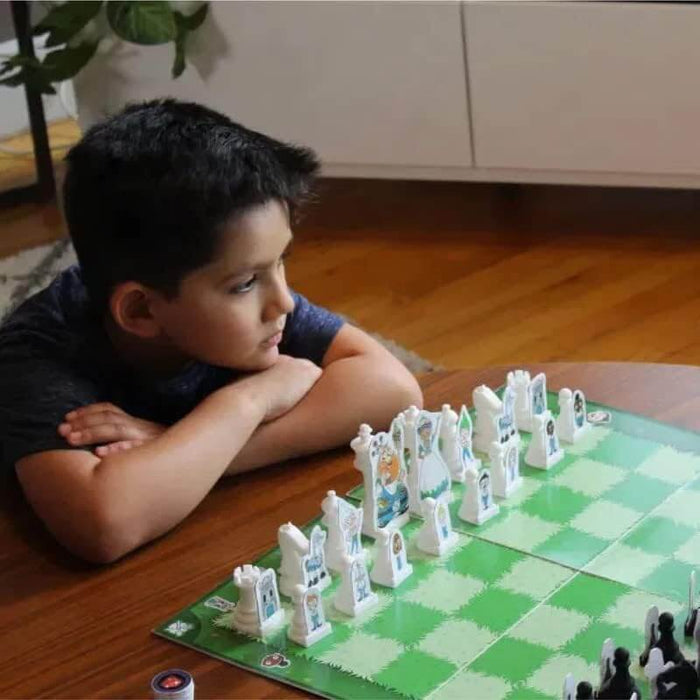 A young boy focuses on a green checkered chessboard with white pieces illustrated as storybook characters.
