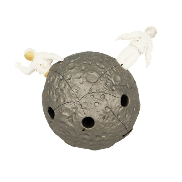 Textured gray moon sphere with holes and two small white stretchy astronauts popping out from the top.