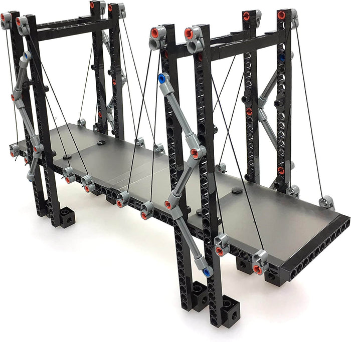 Plastic model suspension bridge with black support beams, a grey deck, and black string cables.
