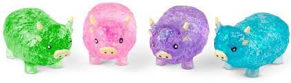 Four translucent, textured Highland cow toys in green, pink, purple, and blue with tiny yellow horns and ears.