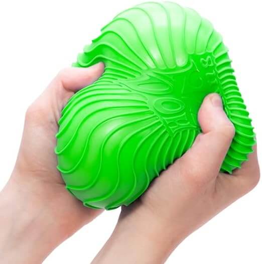 Hands squeezing a large, bright green squishy ball with deep rippled ridges to show its soft texture.