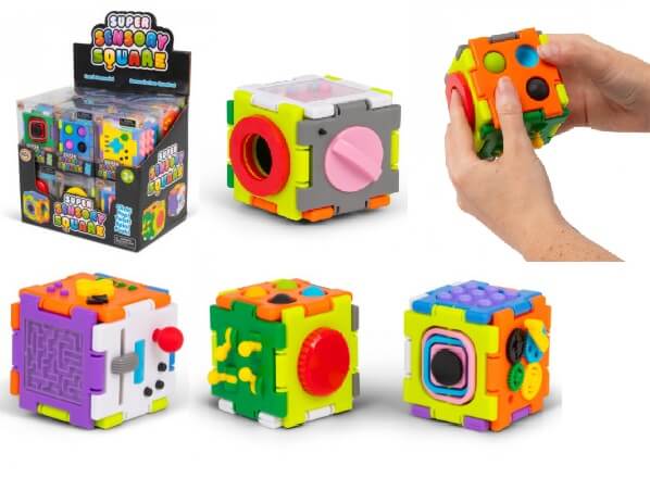 Brightly colored modular fidget cubes with buttons, gears, and mazes in a retail box and being held by hands.