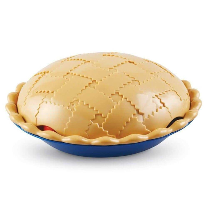 Toy pie with a tan, textured lattice lid and scalloped crust resting in a deep blue plastic bowl.