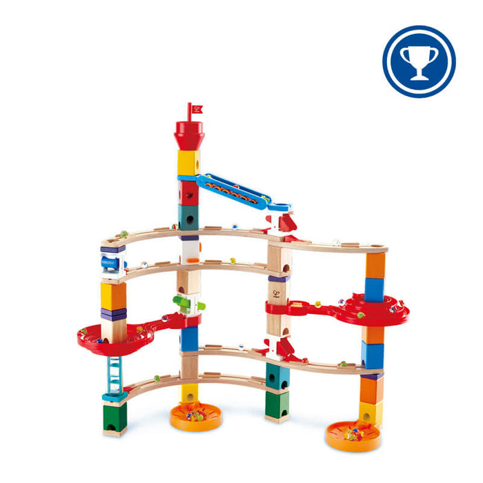 Multi-tiered wooden marble run featuring colorful blocks, curved tracks, red spiral funnels, and glass marbles.