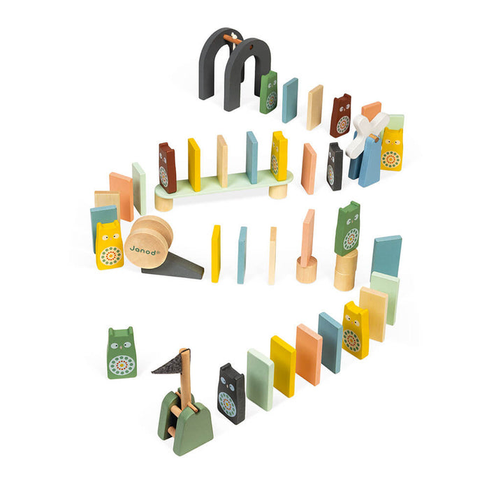 Pastel wooden dominoes and obstacles like arches and a windmill arranged in a winding path.