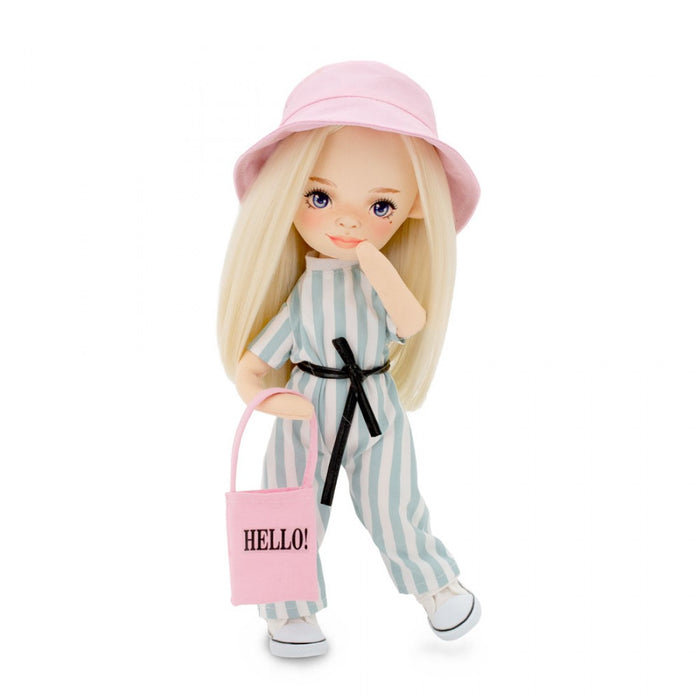 Blonde doll in blue and white striped jumpsuit, pink bucket hat, and pink tote bag with HELLO! text.