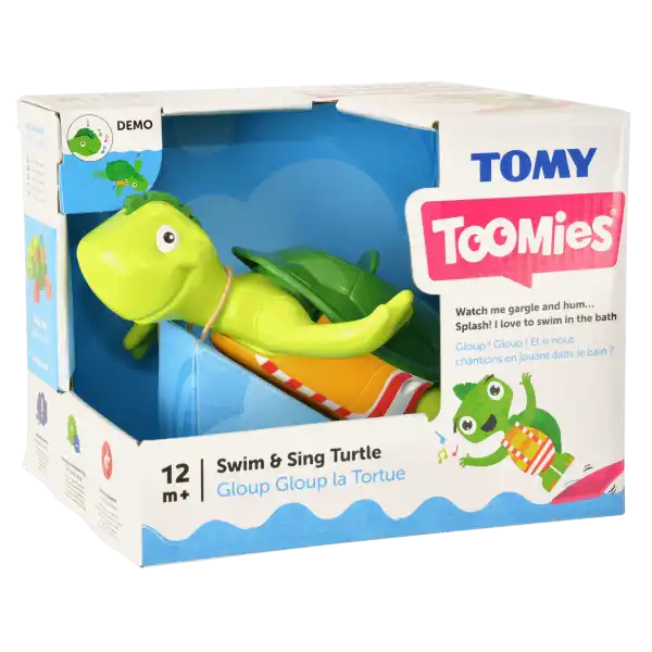 Lime green plastic bath turtle toy in a white cardboard box with Toomies branding, wearing a colorful striped swimsuit.