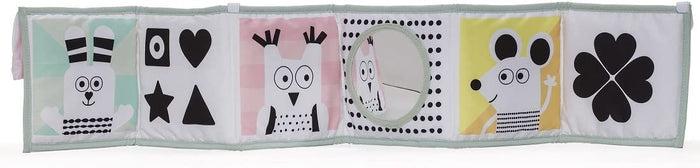 A soft accordion-style baby book featuring high-contrast black and white animal and geometric patterns on pastel panels.