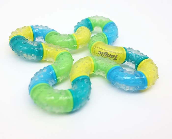 Textured fidget toy with bumpy, translucent yellow, blue, and green curved segments connected in a twisty loop.
