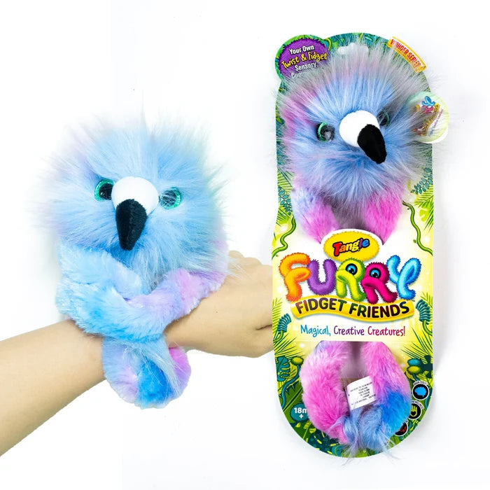 Fluffy blue and pink bird-like toy wrapped around a wrist and shown in its colorful jungle-themed retail packaging.