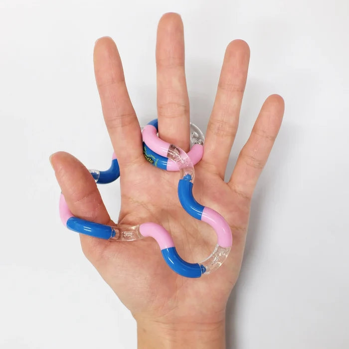 Blue, pink, and clear articulated fidget toy woven through the fingers of an open hand against a white background.