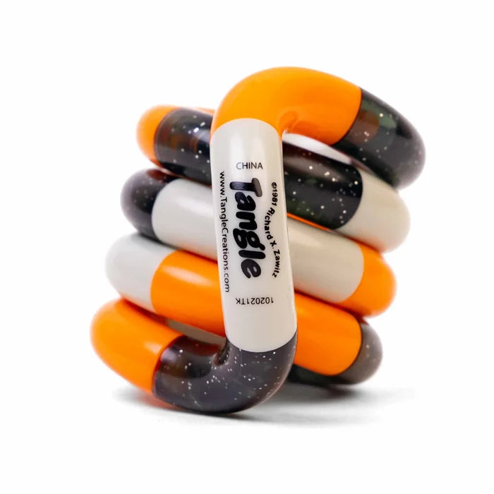 Coiled sensory toy with interlocking orange, white, and glittery dark curved segments.