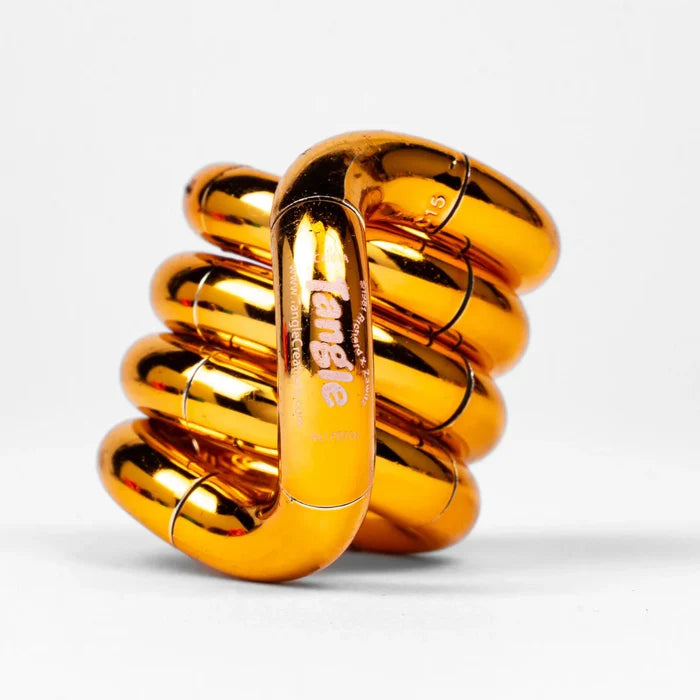 Shiny metallic orange Tangle fidget toy with interlocking curved segments twisted into a compact coiled stack.
