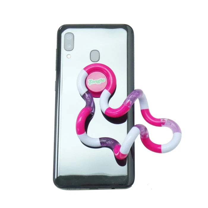 Pink, white, and purple winding fidget toy attached to the back of a black smartphone.