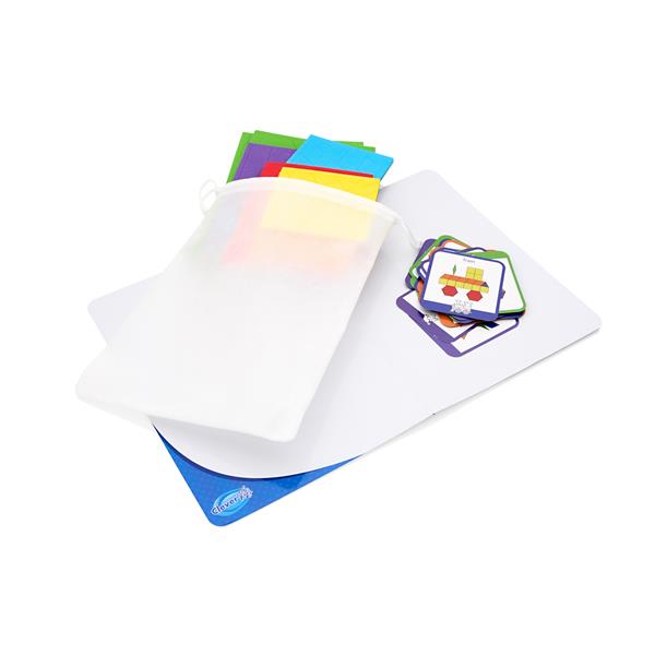 Colorful geometric shapes, design cards, and a white mesh drawstring bag on a white board.