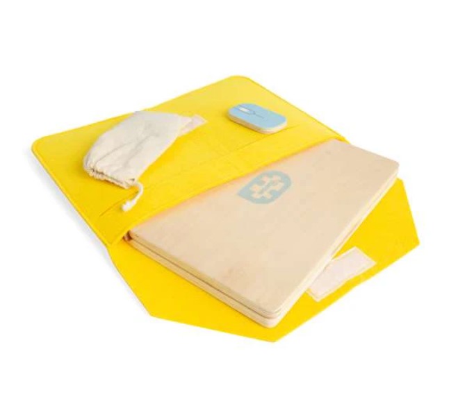 Open yellow felt case holding a wooden toy laptop, a light blue wooden mouse, and a small white drawstring bag.