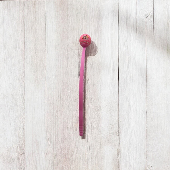 DogTreatNZ tennis ball launcher for dogs, showing the handheld device with a tennis ball ready for play.