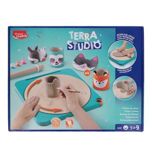 Box for Terra Studio clay kit showing a manual teal potter's wheel, clay, tools, and finished animal-themed pottery.
