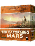 Orange board game box showing two astronauts on a Martian landscape with green trees and a falling comet.
