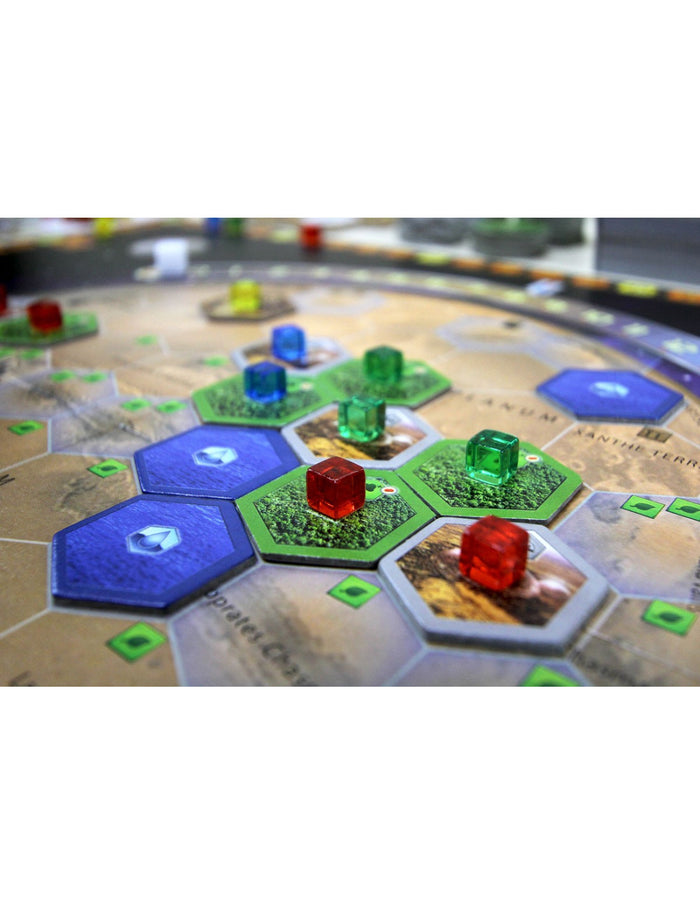 Hexagonal forest and ocean tiles with small translucent marker cubes on a Mars-themed game board.