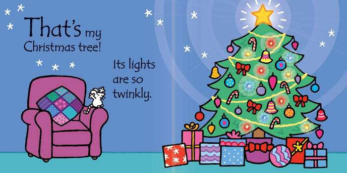 A white mouse on a purple armchair beside a decorated Christmas tree with glowing yellow lights and colorful gifts.