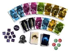 Colorful space-themed cards fanned out with purple tiles, round tokens, and a small black astronaut figurine.
