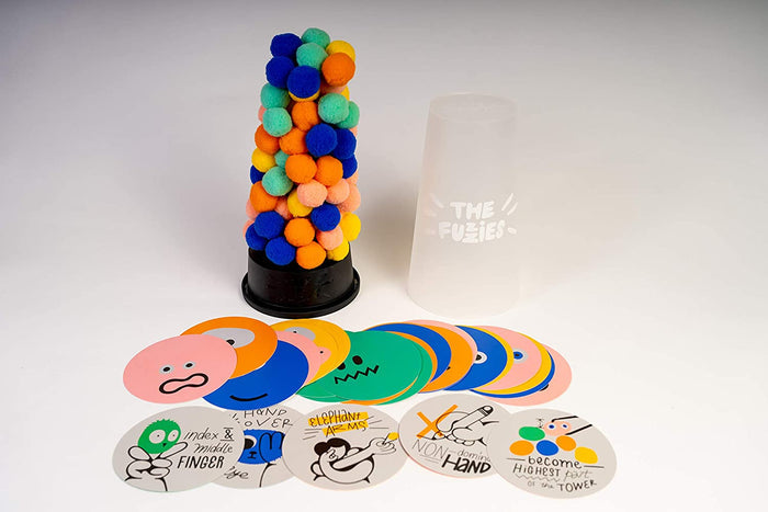 Tower of multi-colored fuzzy balls next to a translucent container and illustrated circular game cards.