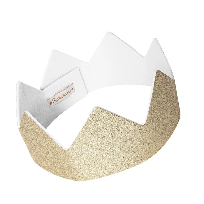 Gold glitter crown with five pointed peaks, a soft white interior, and a small brand label.