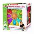 Colorful toy box for an activity cube featuring a rainbow pop-it flower face, shape sorting side, and a toddler playing.